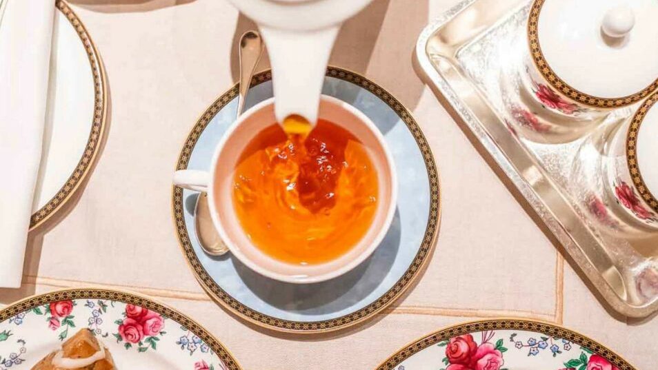 British tea culture-Black tea being poured into teacup
